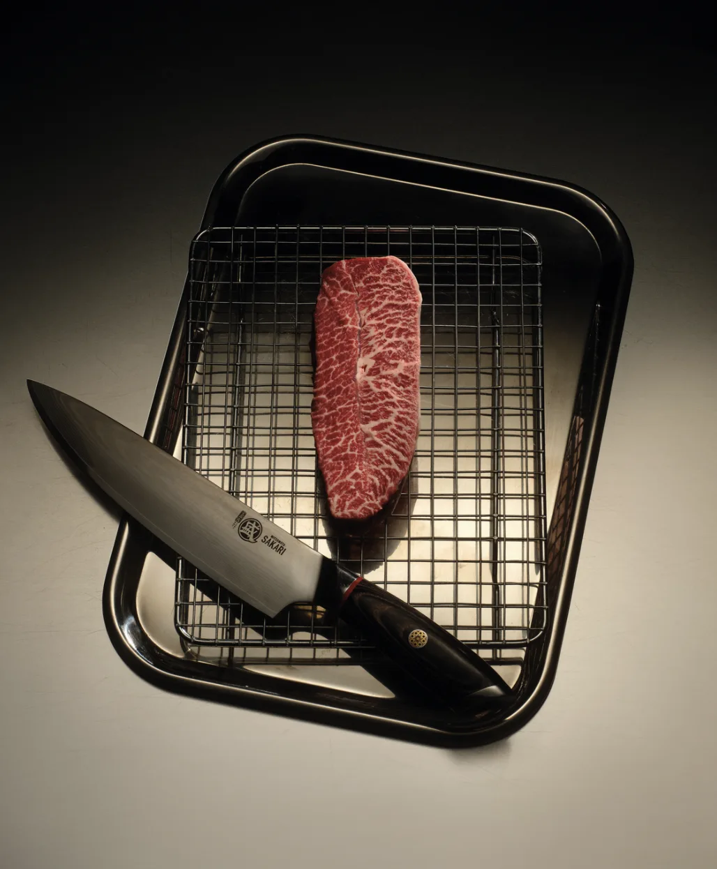 ICON Wagyu steak ready for preparation beside a carving knife