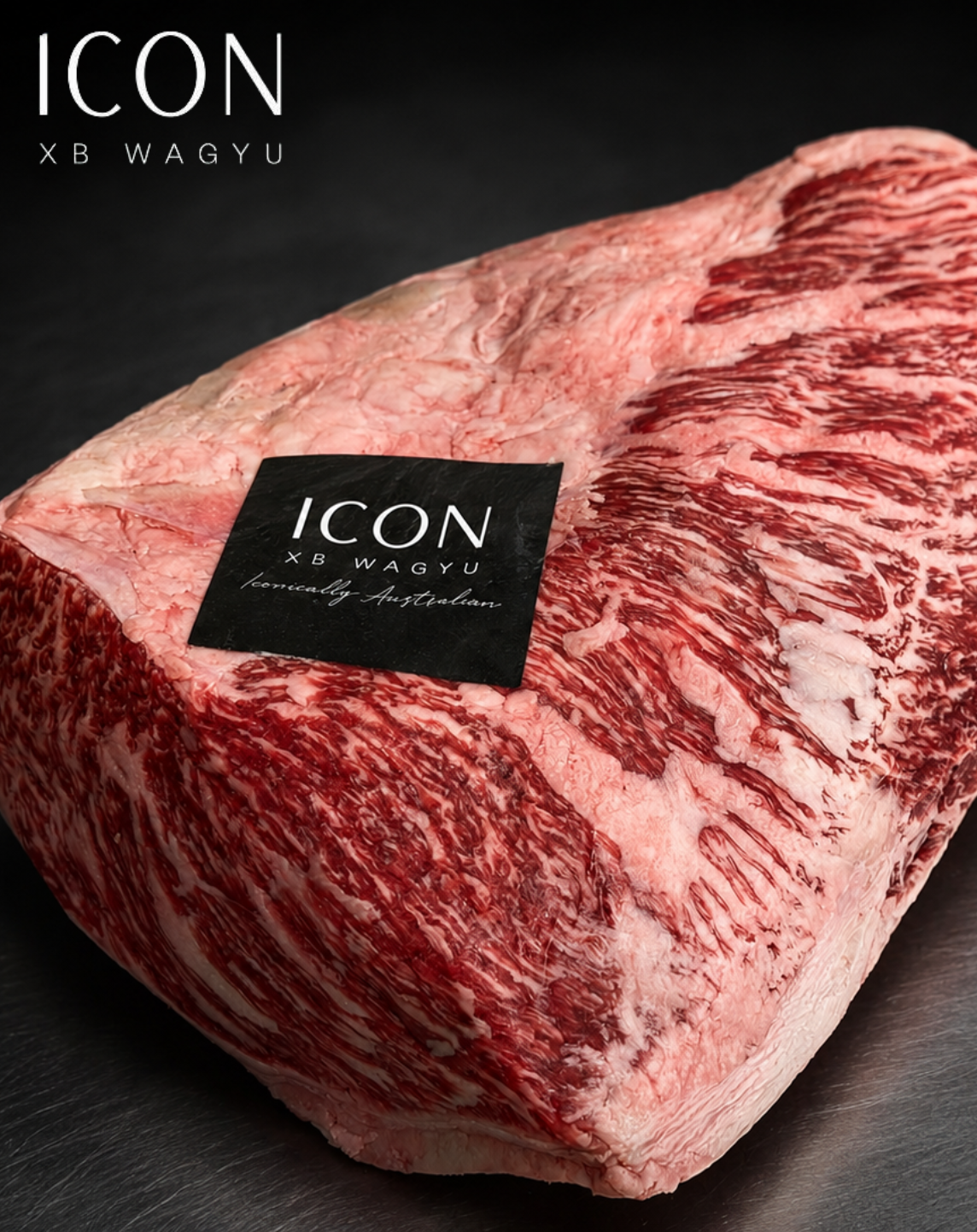 Marbled ICON Wagyu steak on a metal tray with potatoes